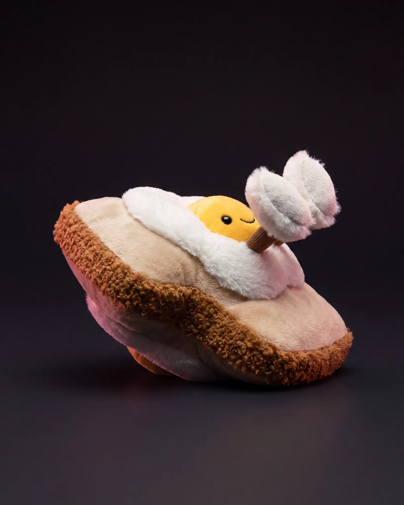 Amuseables Egglantine Egg On Toast on a dark studio background.