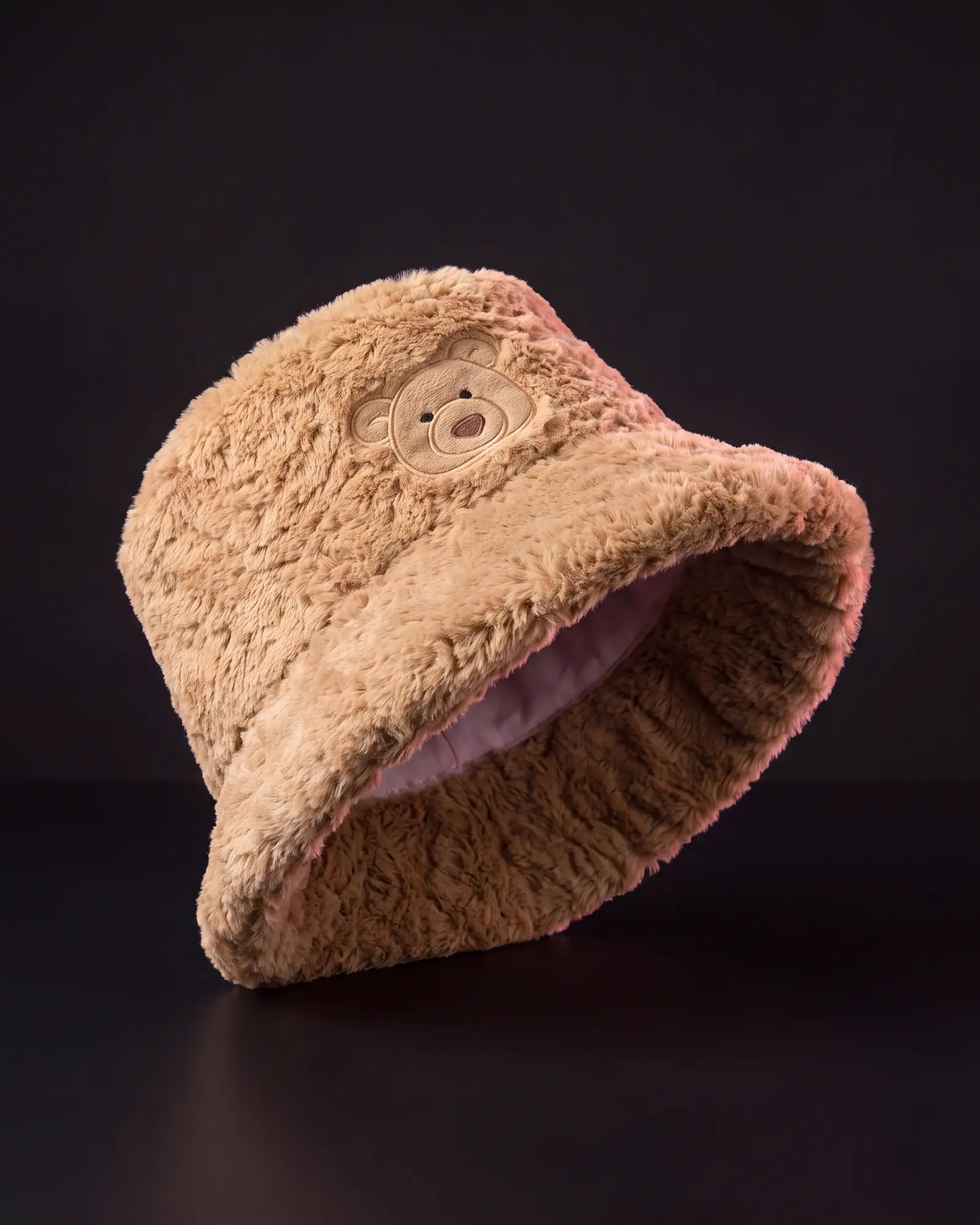 Bartholomew Bear Fluffleshade Hat on a dark studio background.