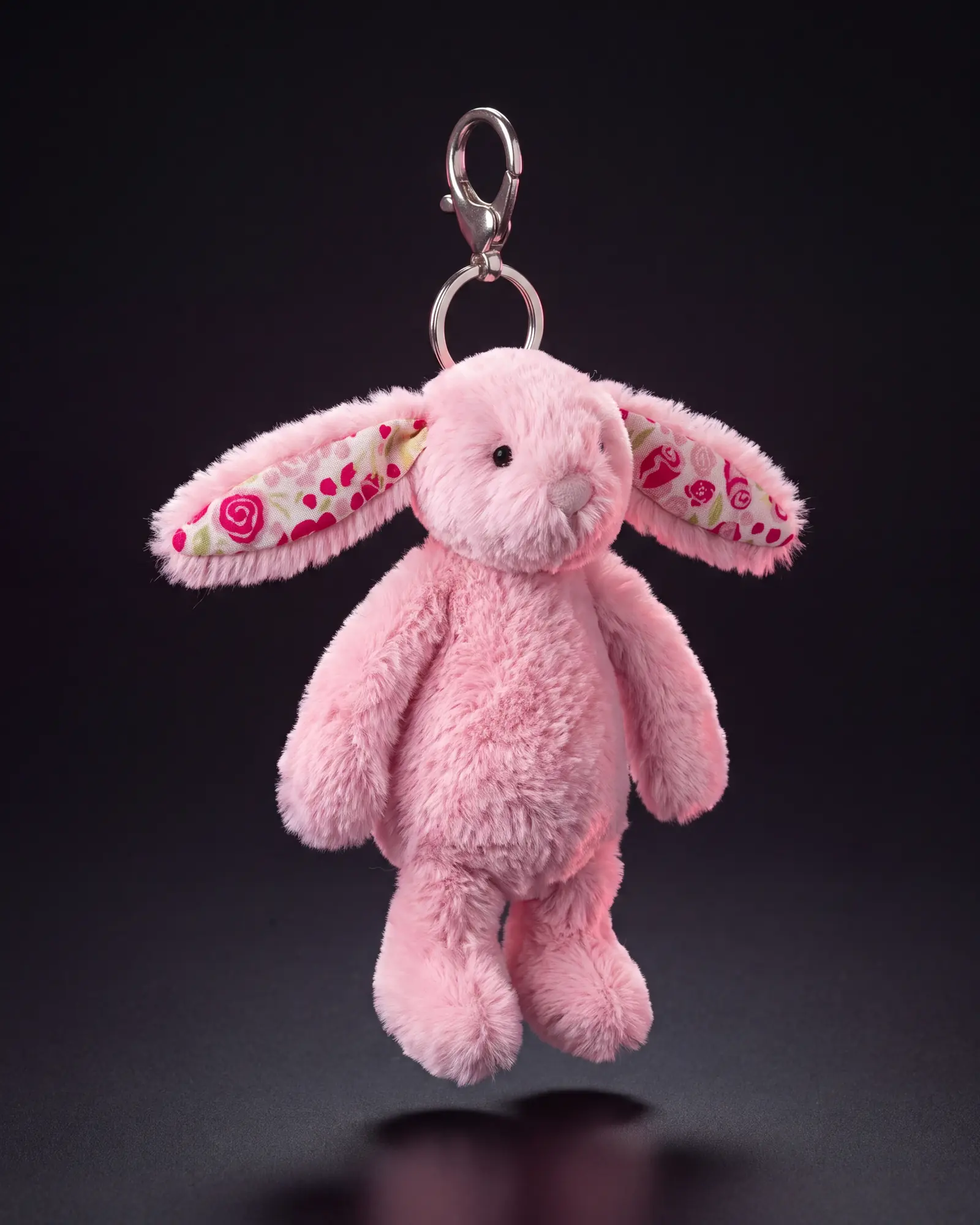 Blushkin Blossom Bunny Bag Charm on a dark studio background.