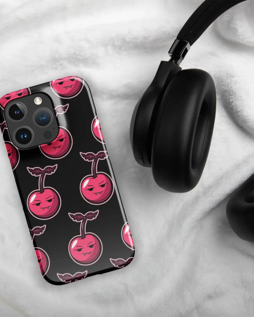 Cherry Case face-up next to headphones.