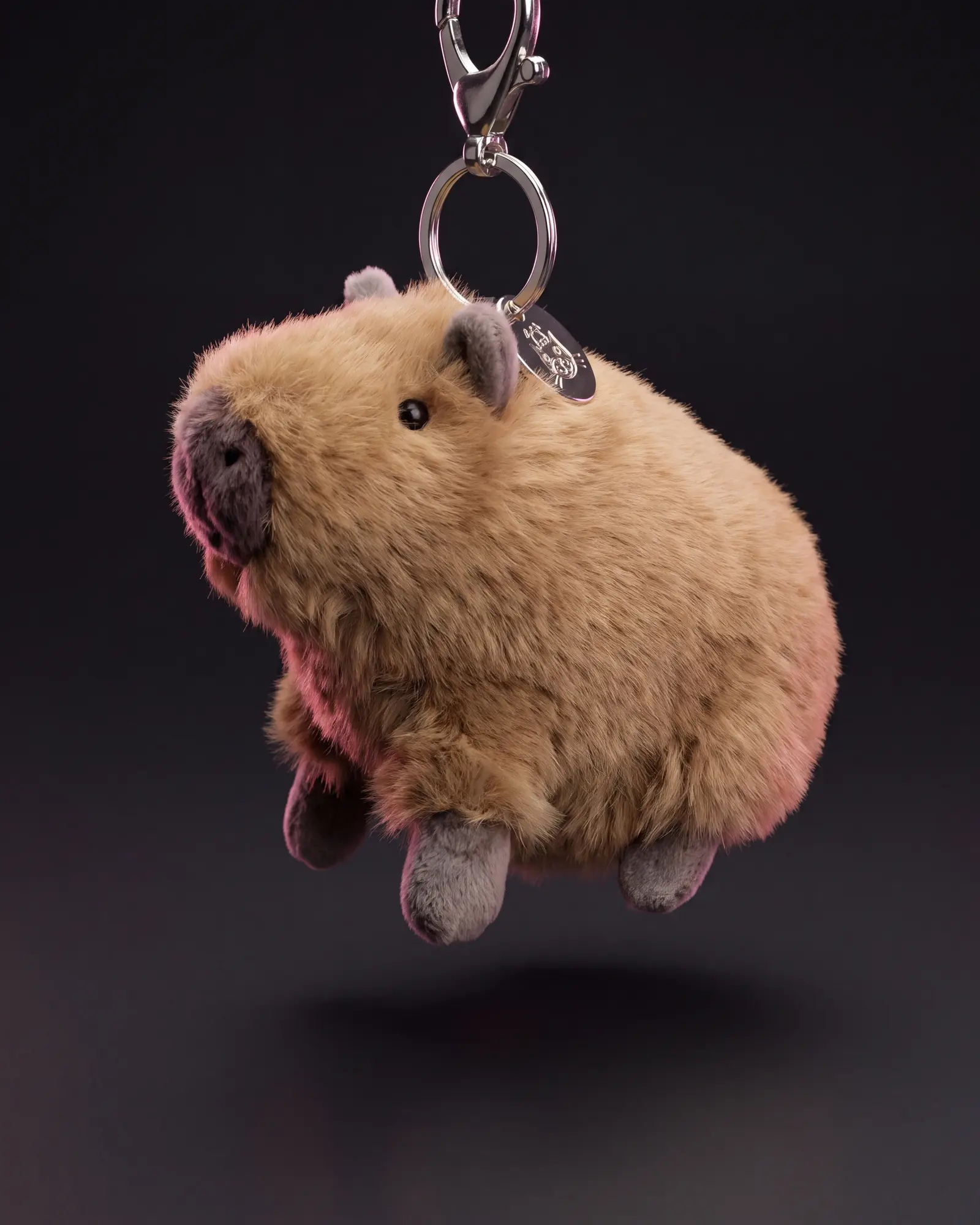 Clyde Capybara Bag Charm on a dark studio background.